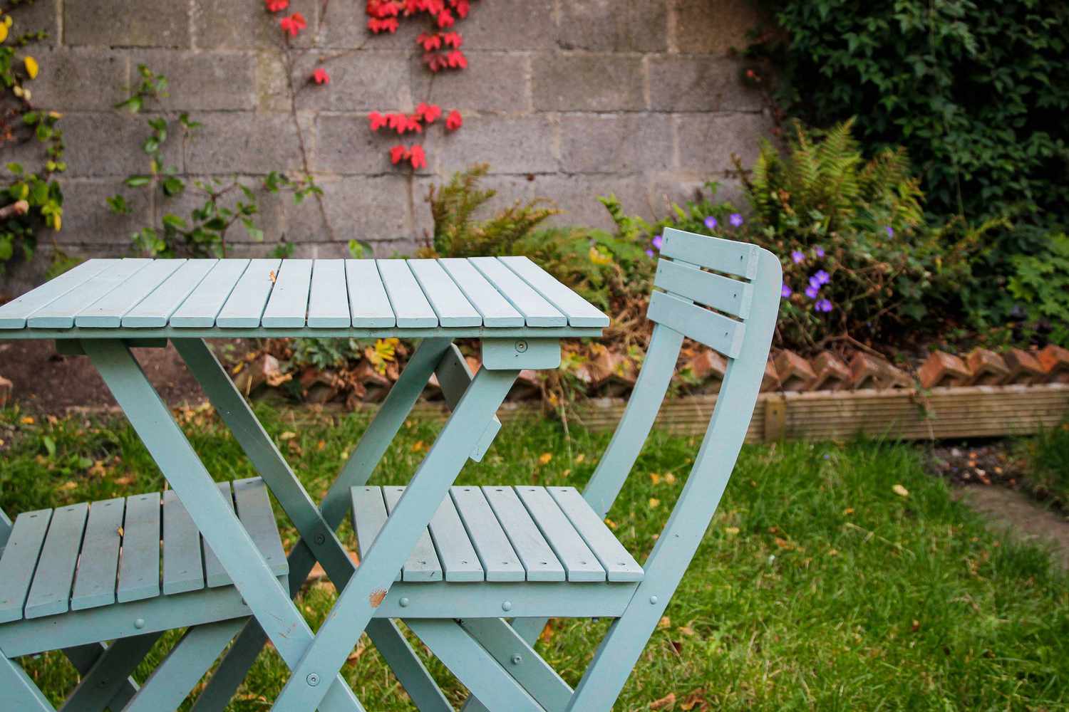 Table et chaises extérieures bleues dans une arrière-cour